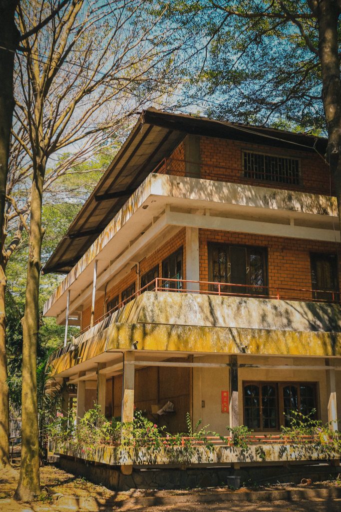 A serene multistory home surrounded by lush trees in Hồ Chí Minh City, Vietnam.